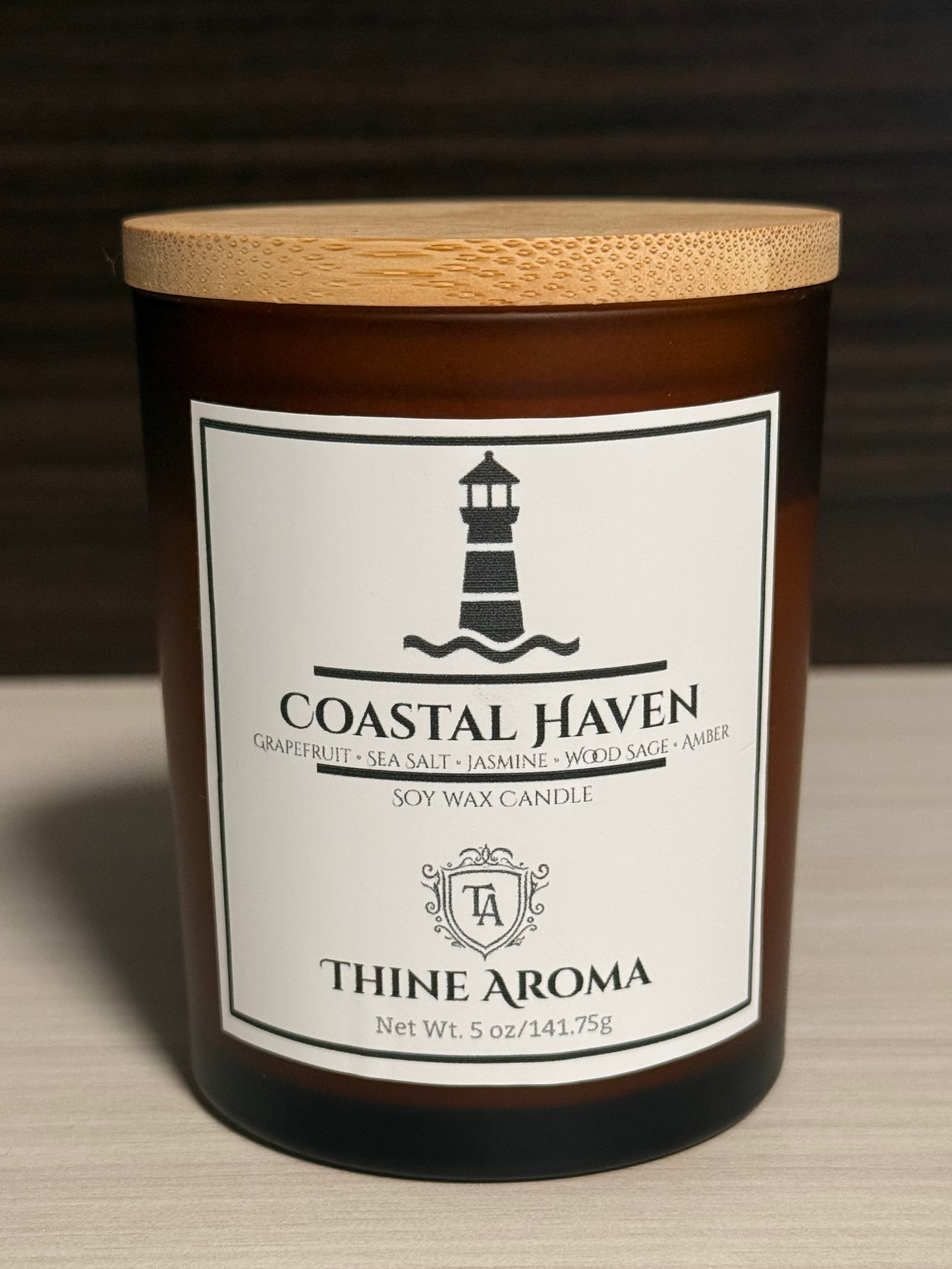 Coastal Haven candle with a wooden lid on a neutral background